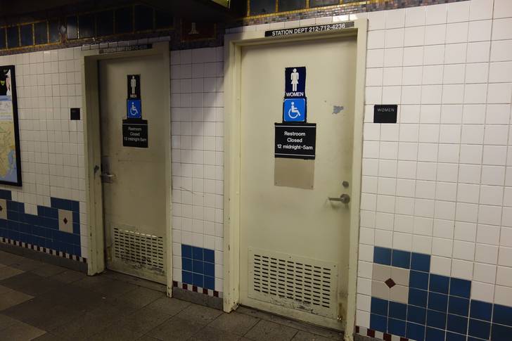 The doors of two bathrooms in the Flatbush Avenue–Brooklyn College subway station.